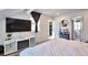 Comfortable bedroom featuring a TV, fireplace, neutral decor, and access to other rooms at 13462 E Asbury Dr, Aurora, CO 80014