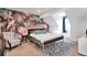 Attractive bedroom featuring bright tropical wallpaper, comfortable furniture, and a cozy rug at 13462 E Asbury Dr, Aurora, CO 80014