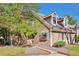 Charming home exterior boasts mature trees, fresh paint, and well-maintained landscaping on a sunny day at 13462 E Asbury Dr, Aurora, CO 80014