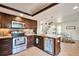 Well-equipped kitchen featuring stainless steel appliances, granite countertops, and ample cabinet space at 13462 E Asbury Dr, Aurora, CO 80014