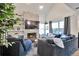 Inviting living room features a stone fireplace, large windows, and comfortable seating arrangement at 13462 E Asbury Dr, Aurora, CO 80014