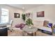 Inviting living room with a comfortable sofa, desk, and a bookshelf, perfect for relaxation and productivity at 13462 E Asbury Dr, Aurora, CO 80014