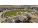 An aerial view highlights a planned community with central green space and recreational areas, showcasing community amenities at 27837 E 8Th Ave, Aurora, CO 80018