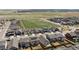 An aerial view features a residential neighborhood with large green spaces, showcasing community planning and nearby homes at 27837 E 8Th Ave, Aurora, CO 80018