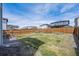 Expansive backyard featuring a dining set, grassy area, and wooden privacy fence at 27837 E 8Th Ave, Aurora, CO 80018