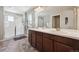 Bathroom with dual sinks, large mirror, updated vanity and walk-in shower at 27837 E 8Th Ave, Aurora, CO 80018