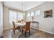 Cozy dining area with a modern chandelier, stylish chairs, and plenty of natural light at 27837 E 8Th Ave, Aurora, CO 80018