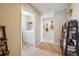 Hallway with beige carpet with decor such as guitars and ram horns on the wall at 27837 E 8Th Ave, Aurora, CO 80018