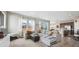 Spacious living room with hardwood flooring, large windows, and a comfortable sectional sofa at 27837 E 8Th Ave, Aurora, CO 80018