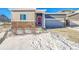 House exterior featuring a two-car garage and a red front door at 12785 Horton Ct, Parker, CO 80134