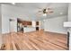 Open concept living room with hardwood floors and kitchen access at 12785 Horton Ct, Parker, CO 80134