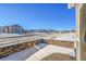 Stone retaining wall and snowy side yard with view of neighborhood at 12785 Horton Ct, Parker, CO 80134