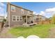 Exterior features a covered back patio perfect for entertaining, large lawn, and wood fence at 6484 N Ceylon Ct, Denver, CO 80249
