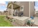 Large covered patio, grill, and outdoor seating make this backyard perfect for entertaining at 6484 N Ceylon Ct, Denver, CO 80249