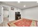 Cozy basement with an electric fireplace, TV stand, and decorative rug for a warm ambience at 6484 N Ceylon Ct, Denver, CO 80249