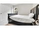 Bedroom featuring a black bedframe, a large closet, and a window for natural light at 6484 N Ceylon Ct, Denver, CO 80249