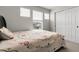 Bedroom featuring a large bed, windows, and closet providing ample storage space at 6484 N Ceylon Ct, Denver, CO 80249