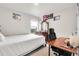 Bedroom with a bed, desk, dresser, and window allowing for lots of natural light at 6484 N Ceylon Ct, Denver, CO 80249