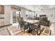 Dining area with a view of the backyard and open to the living room at 6484 N Ceylon Ct, Denver, CO 80249