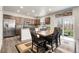Dining area with access to the kitchen and outdoor view through sliding glass door at 6484 N Ceylon Ct, Denver, CO 80249