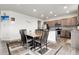Dining room with an adjacent kitchen, a wooden table and six chairs at 6484 N Ceylon Ct, Denver, CO 80249