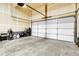 Spacious garage with plenty of room for parking and storage with an automatic overhead door at 6484 N Ceylon Ct, Denver, CO 80249