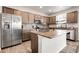 Kitchen with granite countertops, an island, and stainless steel appliances at 6484 N Ceylon Ct, Denver, CO 80249