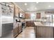 Modern kitchen with stainless steel appliances, granite countertops, and ample cabinet space at 6484 N Ceylon Ct, Denver, CO 80249