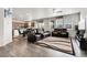 Spacious living room and kitchen combo with hardwood floors and natural lighting at 6484 N Ceylon Ct, Denver, CO 80249