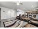 Large living room with hardwood floors, ceiling fan, and a view of the entry way at 6484 N Ceylon Ct, Denver, CO 80249
