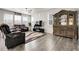 Comfortable living room with hardwood floors, ceiling fan, and large cabinet at 6484 N Ceylon Ct, Denver, CO 80249