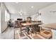 Open-concept living and dining area with hardwood floors and a view of the staircase at 6484 N Ceylon Ct, Denver, CO 80249