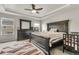 Main bedroom with decorative tray ceiling, fan, and plenty of space for large furniture and crib at 6484 N Ceylon Ct, Denver, CO 80249