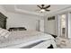 Spacious main bedroom featuring a decorative ceiling, ceiling fan, and access to the main bath at 6484 N Ceylon Ct, Denver, CO 80249