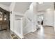 Open staircase leading to the second floor, with views of the entryway and living room at 6484 N Ceylon Ct, Denver, CO 80249