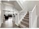 Open staircase leading to the second floor, with views into the bright and spacious living room at 6484 N Ceylon Ct, Denver, CO 80249