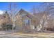 Cozy two-story house featuring brick accents, a well-manicured lawn, and leafless trees at 9978 Salida St, Commerce City, CO 80022