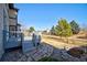 Backyard deck offering serene views of the fenced yard and mature trees at 5521 Longwood Cir, Highlands Ranch, CO 80130