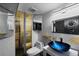 Modern bathroom featuring honeycomb tile, unique sink, gold fixtures, and a custom decorative gold screen at 105 Dudley St, Lakewood, CO 80226