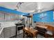 Modern kitchen with stainless steel appliances, gray cabinets and a cozy dining area at 105 Dudley St, Lakewood, CO 80226