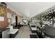 Covered patio featuring comfortable seating, brick wall, decorative privacy panel, and an outdoor grill at 105 Dudley St, Lakewood, CO 80226