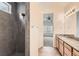 Bathroom features a tiled shower and vanity, with access to the bedroom at 12853 E 108Th Ave, Commerce City, CO 80022