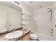 Bright bathroom features vanity with sink, open shelves and shower over tub at 12853 E 108Th Ave, Commerce City, CO 80022