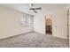 Bright bedroom features neutral carpeting, ceiling fan, and ensuite bath at 12853 E 108Th Ave, Commerce City, CO 80022
