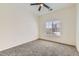 The well-lit bedroom includes plush carpet, neutral walls, and a window with neighborhood views at 12853 E 108Th Ave, Commerce City, CO 80022