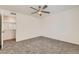 Carpeted bedroom features a ceiling fan and ample natural light at 12853 E 108Th Ave, Commerce City, CO 80022
