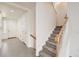 A bright and welcoming entryway flows to a staircase with carpeted steps and white wood handrails at 12853 E 108Th Ave, Commerce City, CO 80022