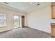 Bright living area with plush carpet, large windows, and sliding glass doors leading to the backyard at 12853 E 108Th Ave, Commerce City, CO 80022