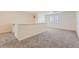 Upstairs carpeted loft space with natural light and neutral paint at 12853 E 108Th Ave, Commerce City, CO 80022