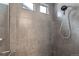 A modern tiled shower with a rainfall showerhead and a convenient handheld shower sprayer at 12853 E 108Th Ave, Commerce City, CO 80022